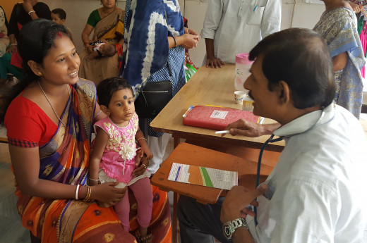 Indian mother and child talking to a doctor