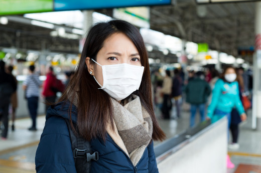 A woman wearing surgical mask in public place