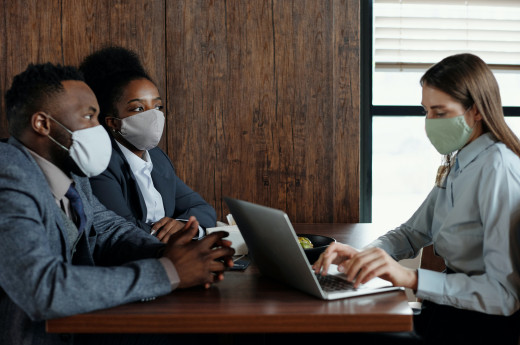 People in a meeting , wearing masks