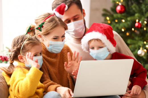 Happy Family in medical masks makes a video call on Christmas holiday in Covid 19 Coronavirus Pandemic