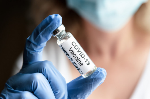 Female Doctor Holds Bottle With Covid-19 Coronavirus Vaccine In Laboratory