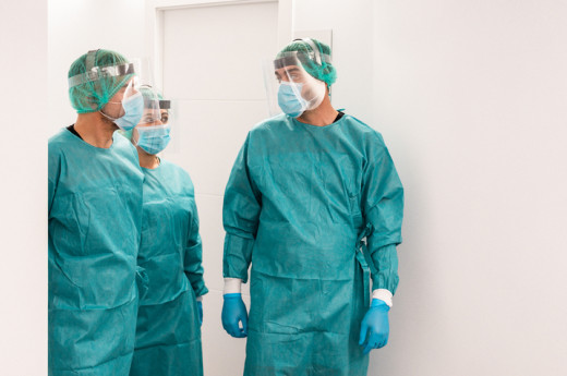 Medical Workers Walking Inside Hospital Corridor During Coronavirus Pandemic Outbreak 