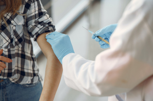 A person receiving COVID 19 vaccine